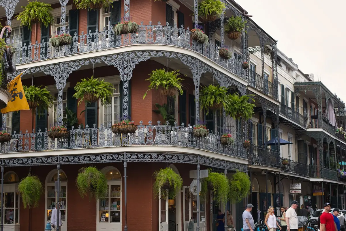 Wrought-iron balconies and greenery on a New Orleans street.